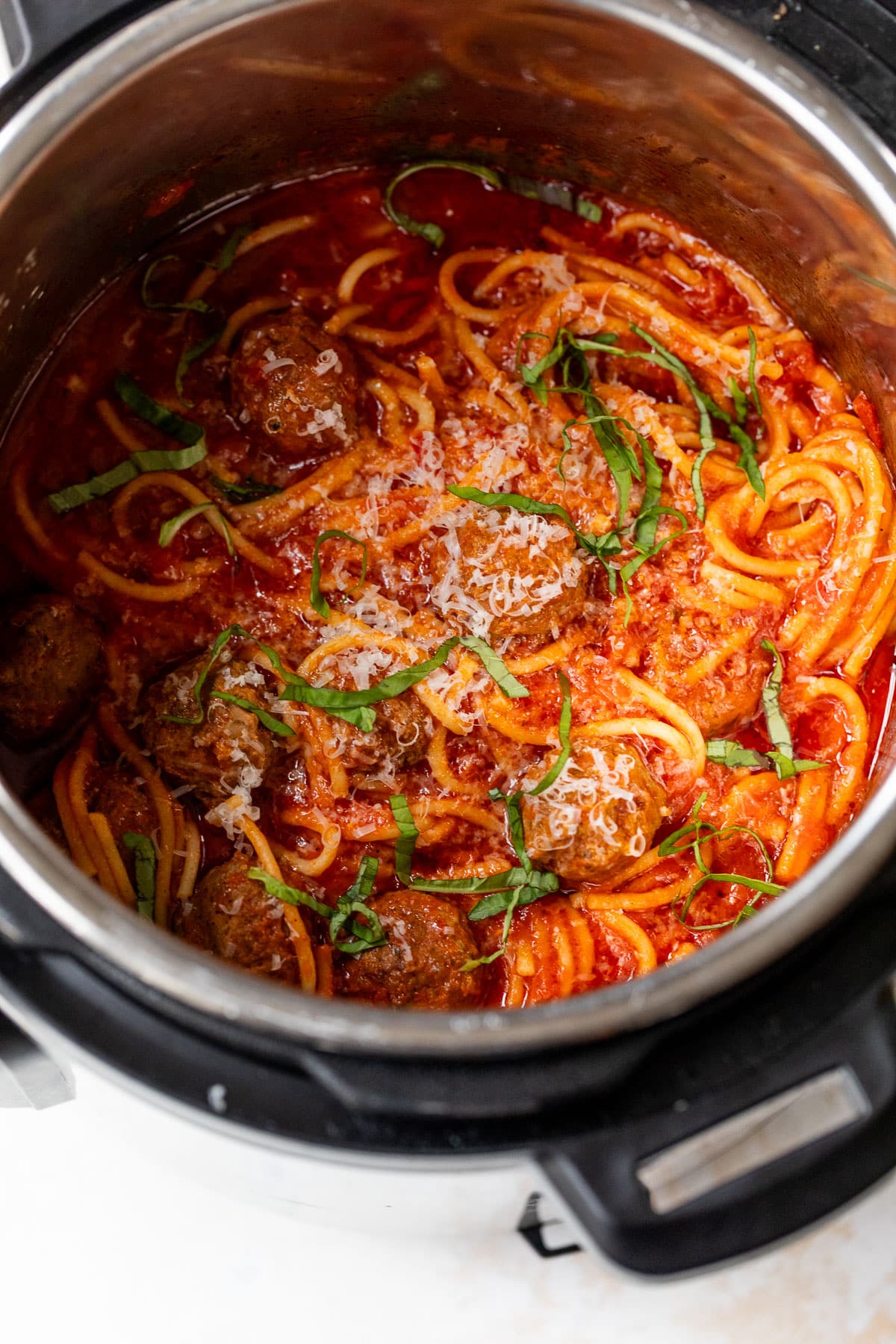 overhead view of spaghetti and meatballs in an instant pot.