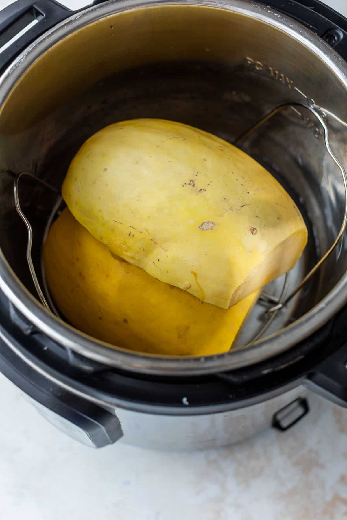 overhead view of two spaghetti squash half's in an instant pot.