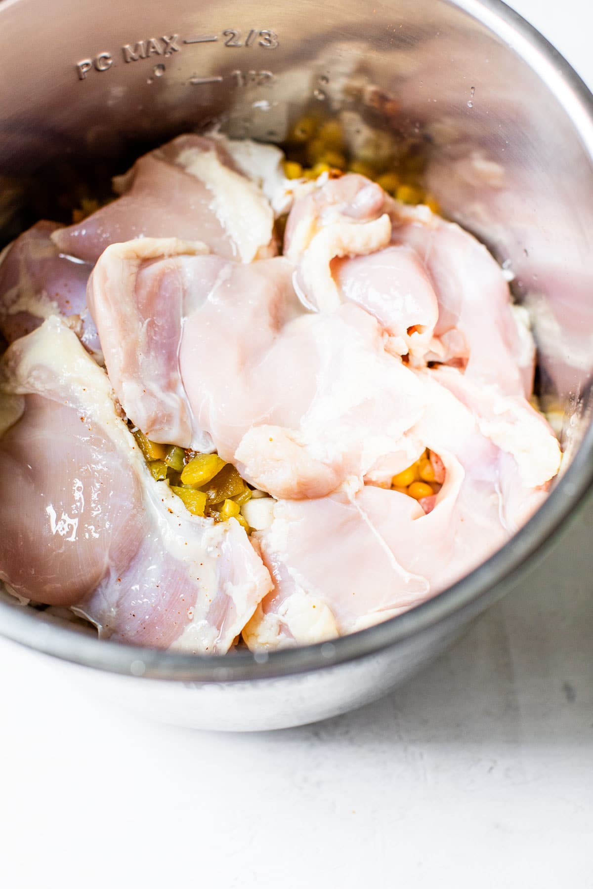 pressure cooker filled with corn and chicken thighs