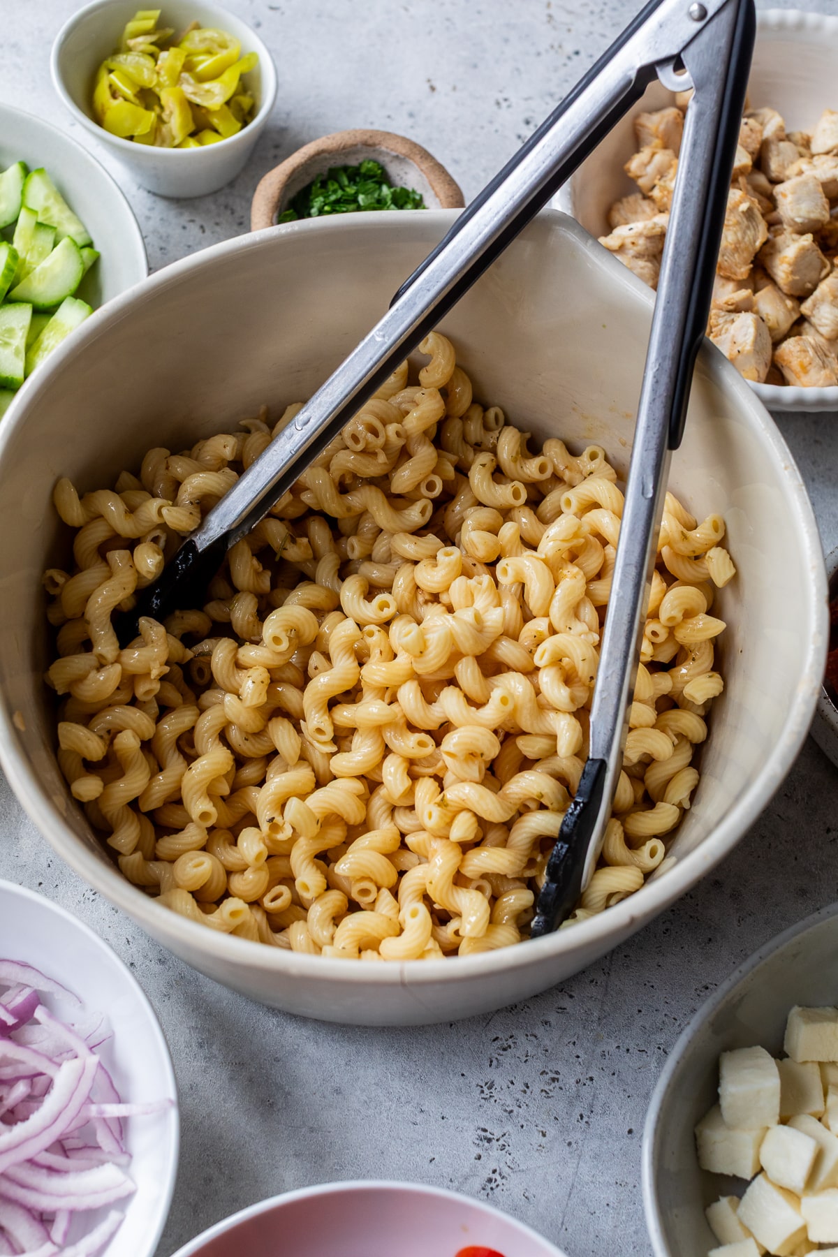 ingredients for Italian pasta salad in individual bowls.