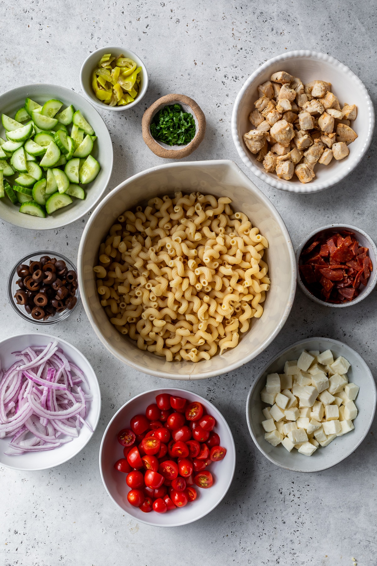 ingredients for Italian pasta salad in individual bowls.