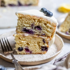 a slice of lemon blueberry cake on a small plate.