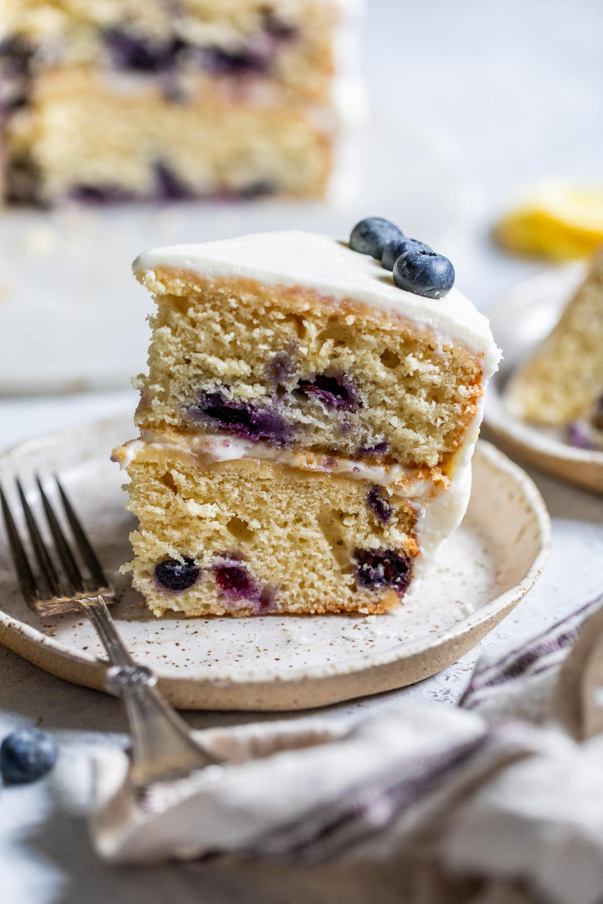 a slice of lemon blueberry cake on a small plate.