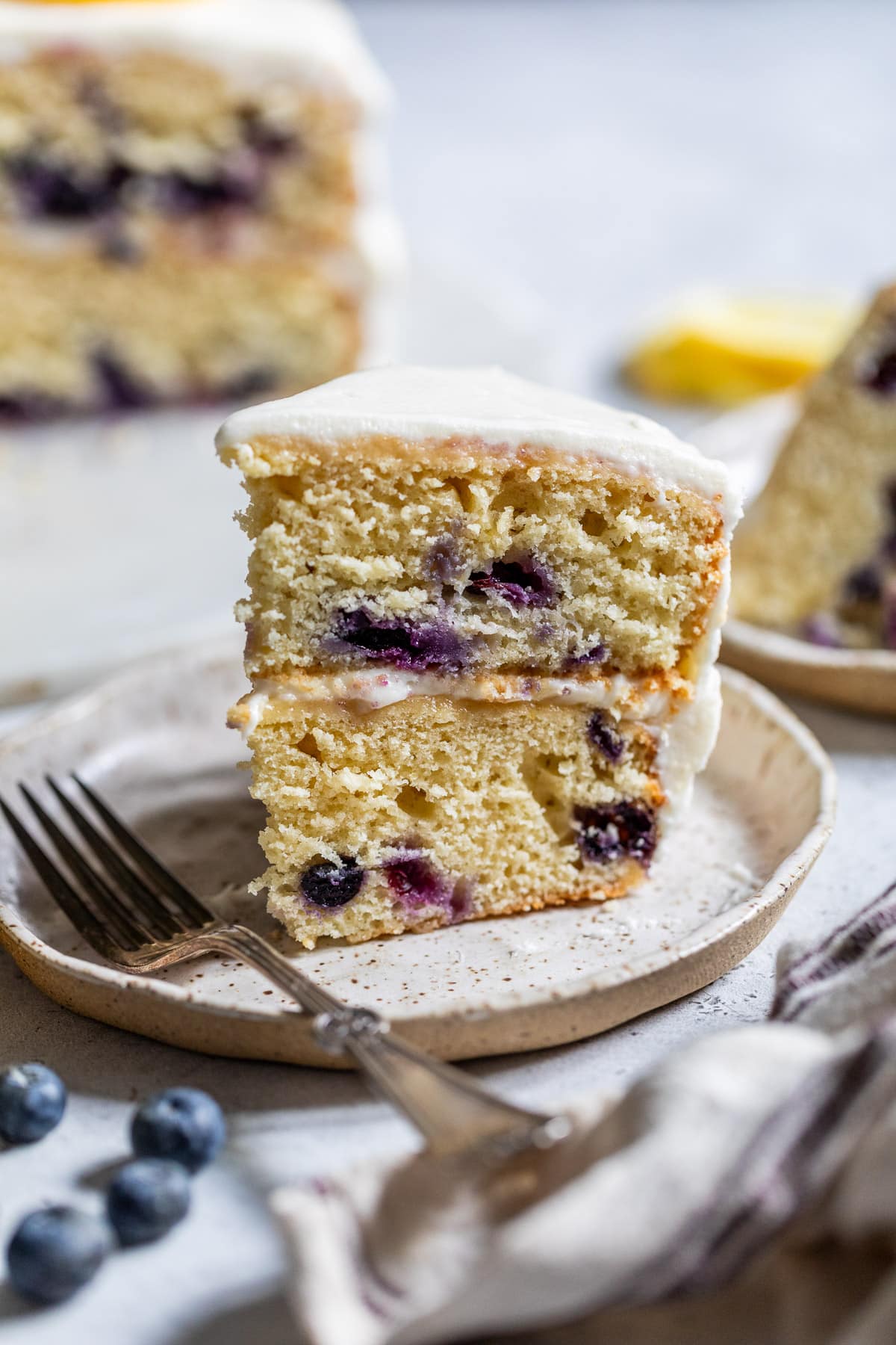 a slice of lemon blueberry cake on a small plate.