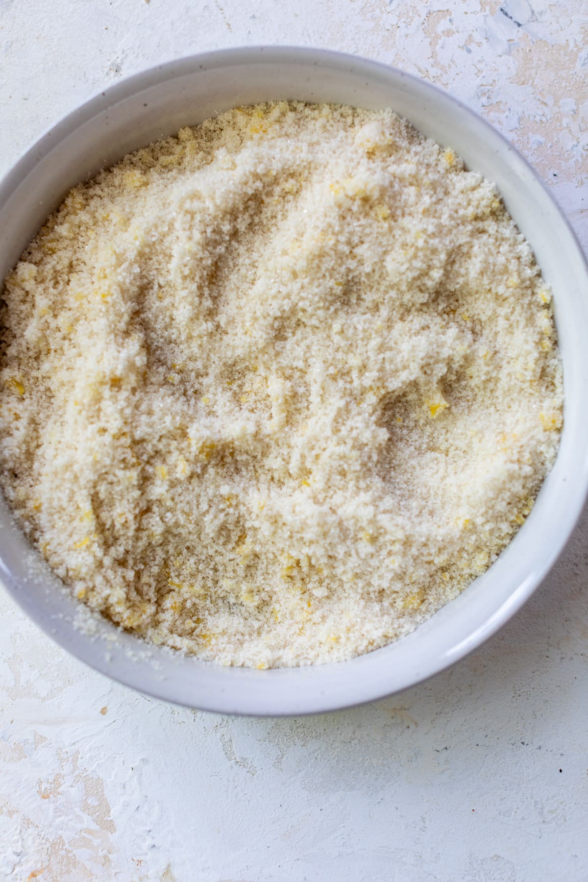 the dry ingredients for lemon blueberry cake in a large white bowl.