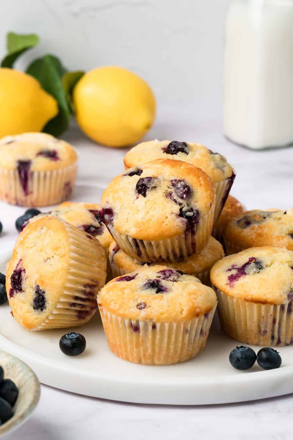side view of a plateful of lemon blueberry muffins.