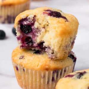 side view of a stack of 2 lemon blueberry muffins.