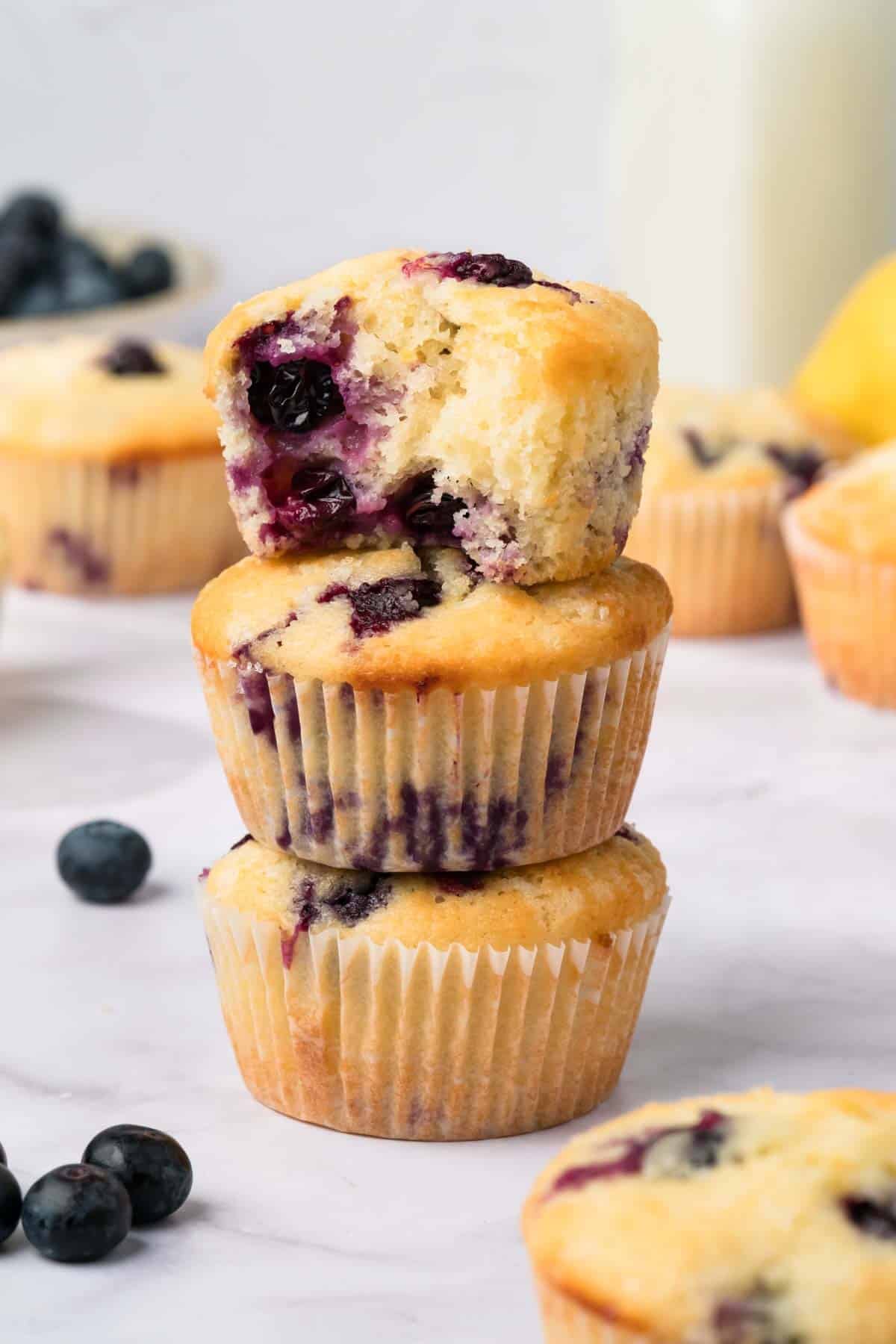 side view of a stack of 3 lemon blueberry muffins.