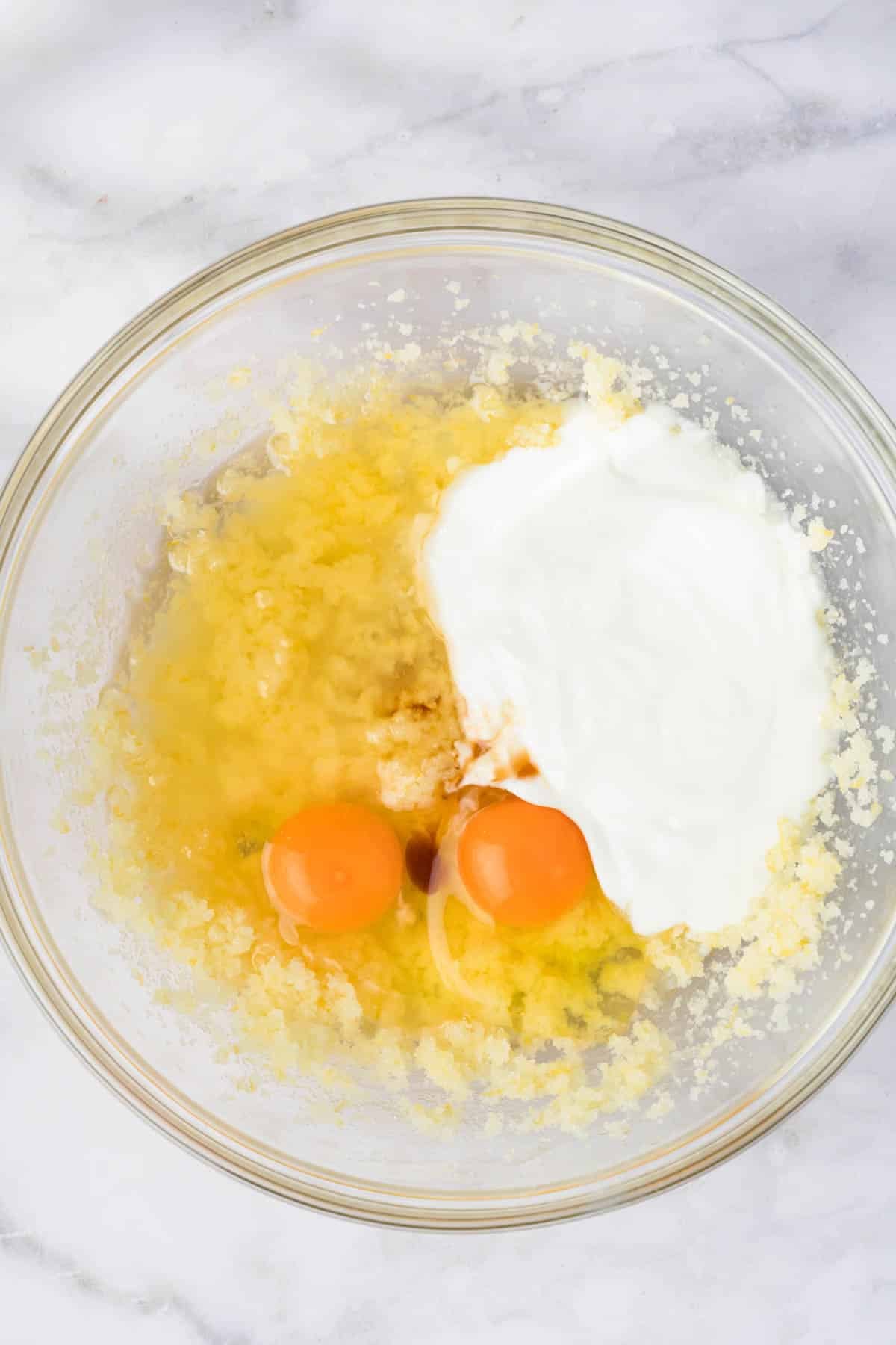 overhead view of the wet ingredients for lemon blueberry muffin batter in a bowl.