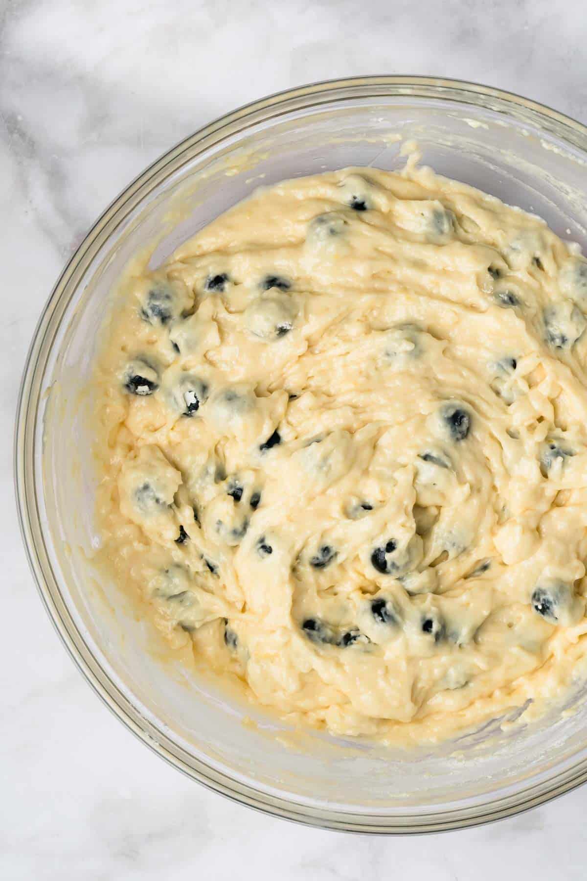 overhead view of lemon blueberry muffin batter in a bowl.