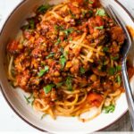 bowl of pasta with red sauce and text overlay