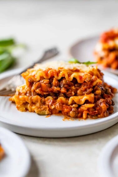 a piece of lasagna on a plate with a fork