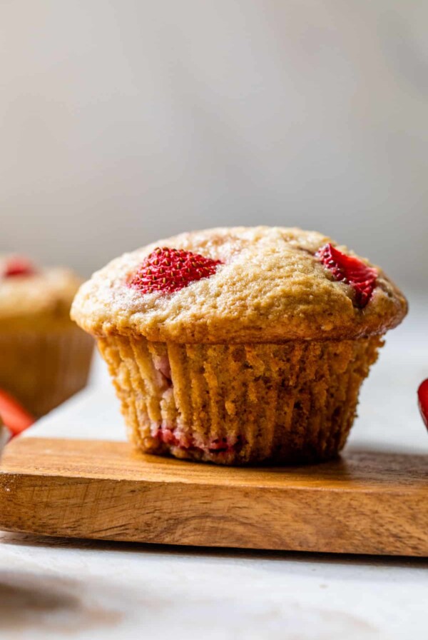 side view of a strawberry muffins on a cutting board