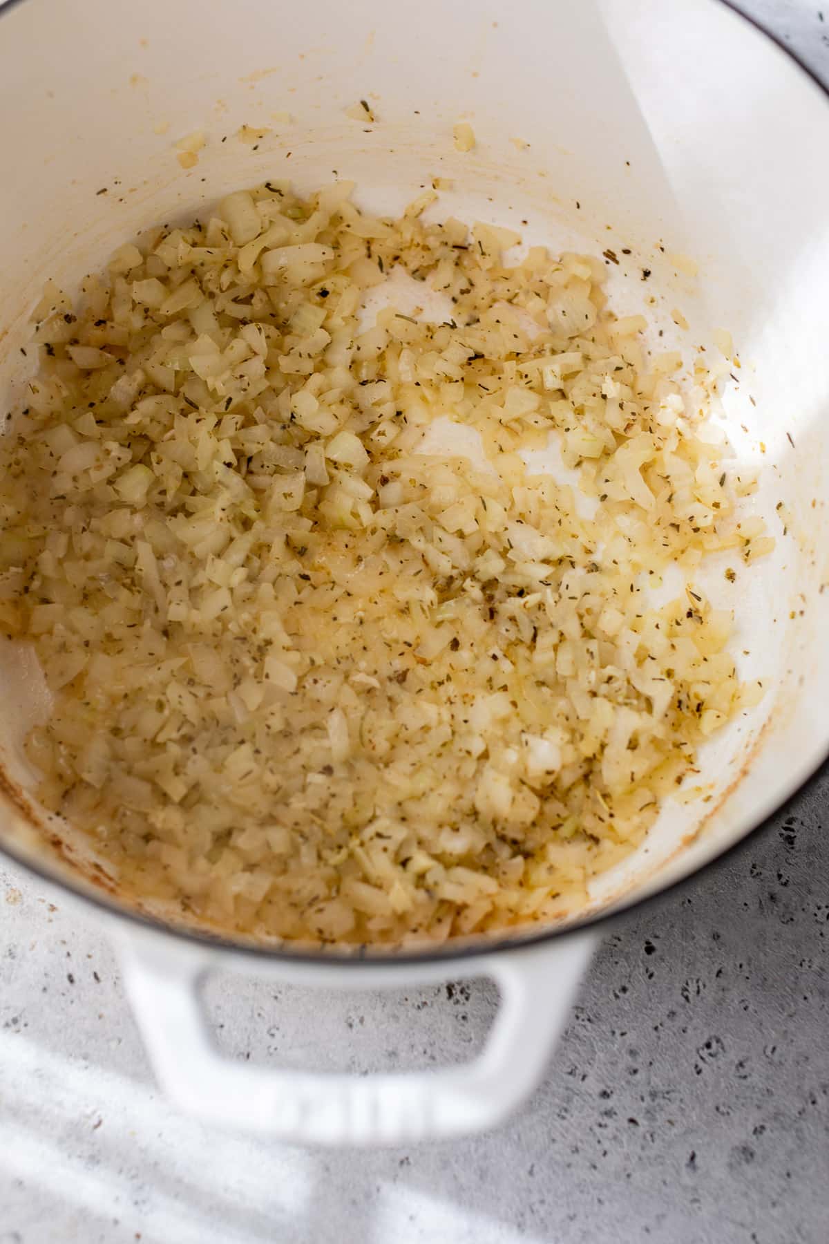 sauteeing chopped onions in a large pot for Marry Me Chicken Soup.