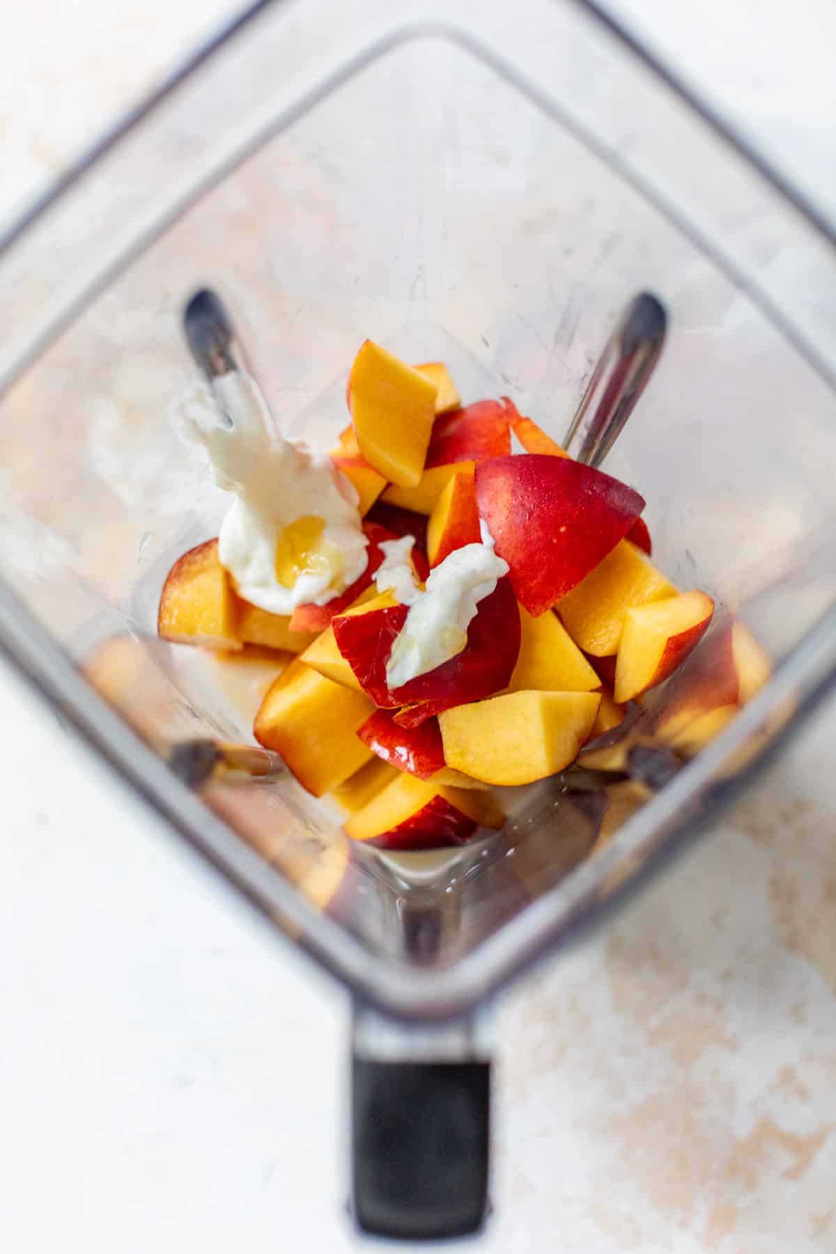 the ingredients for a Nectarine Smoothie in a blender.