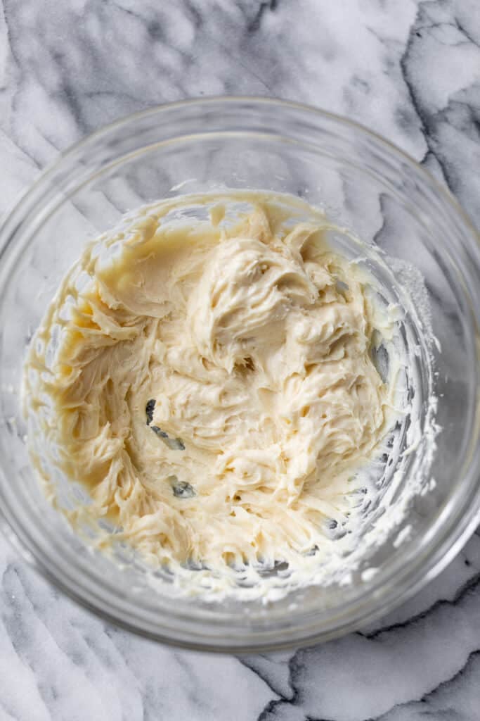 a large glass bowl filled with whipped cream cheese