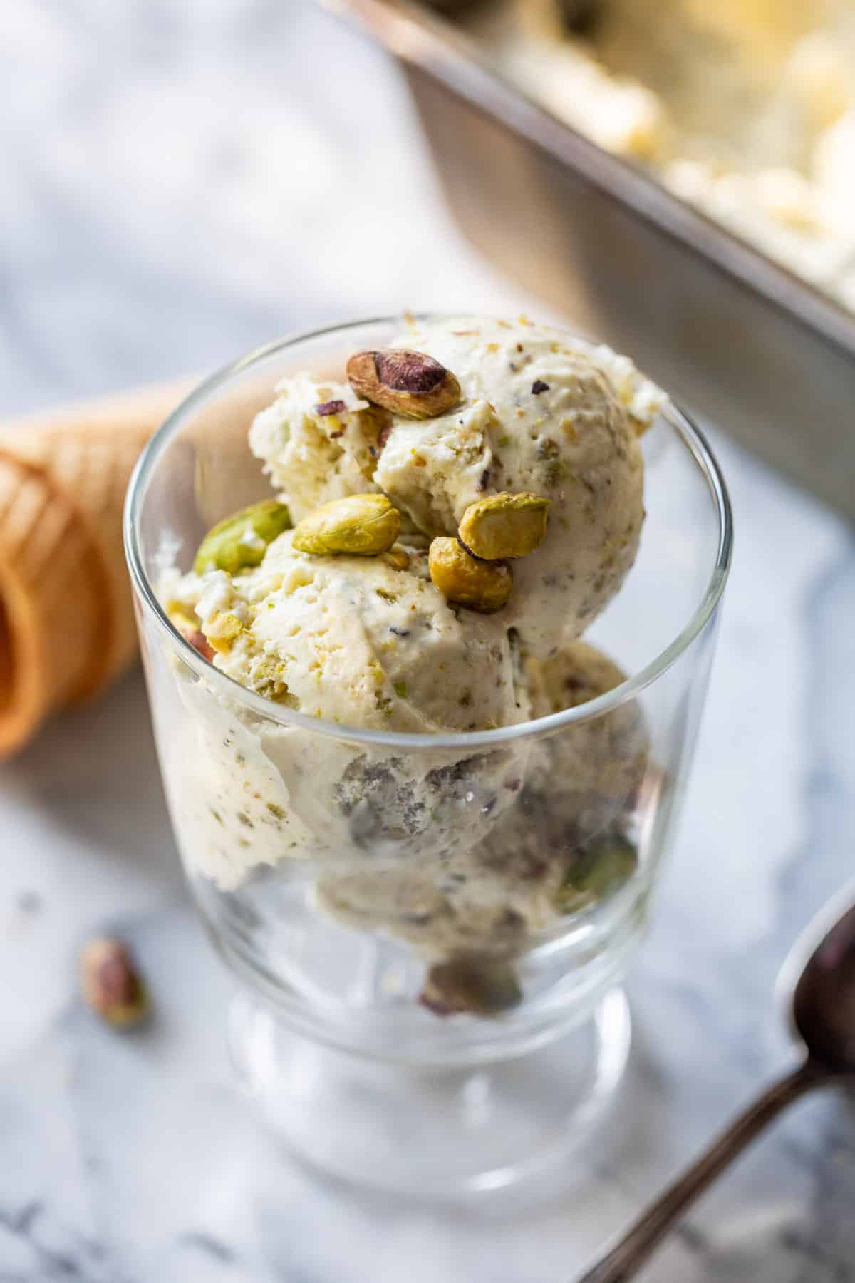 scoops of No Churn Pistachio Ice Cream in a glass.