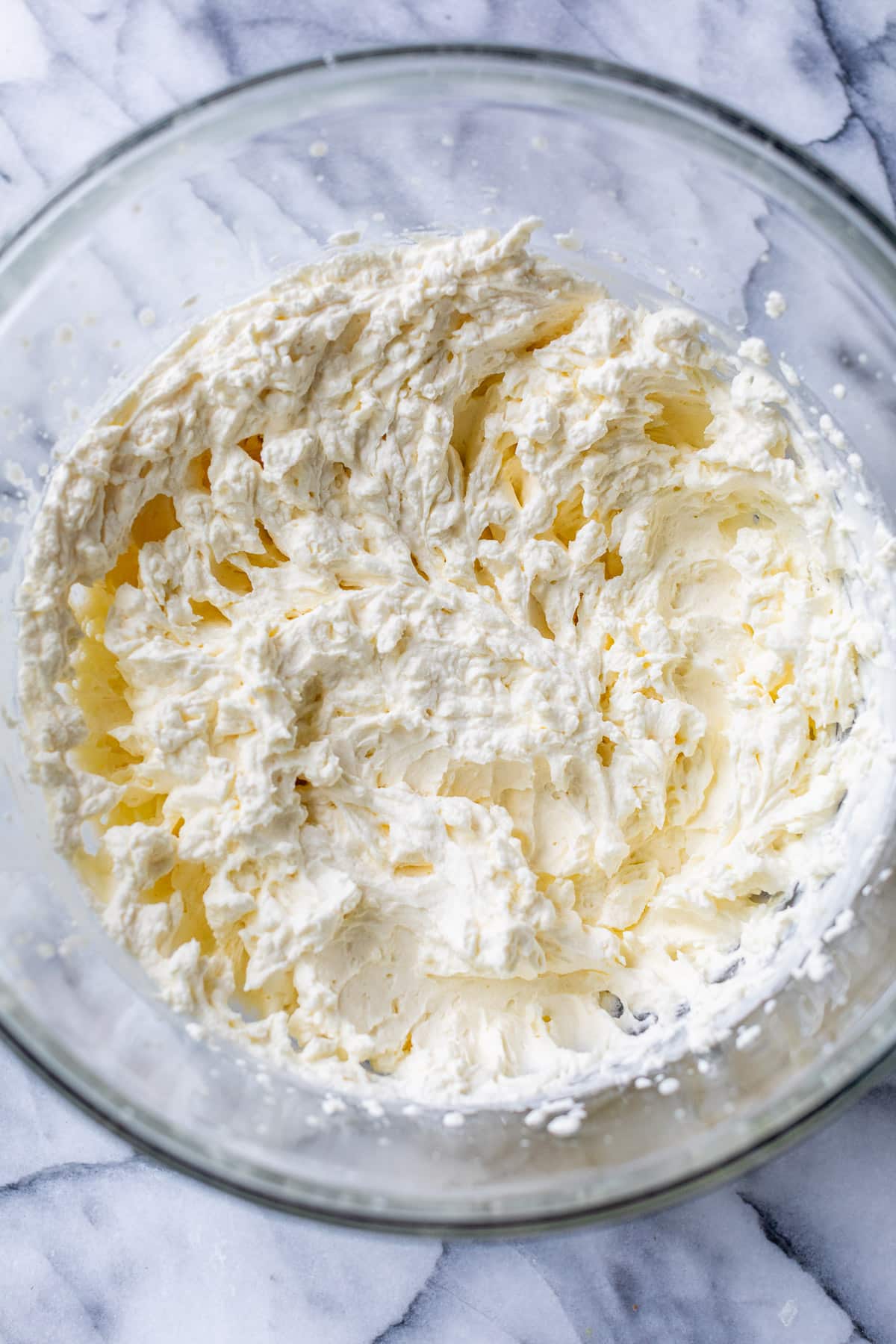 whipped cream in a large glass bowl.
