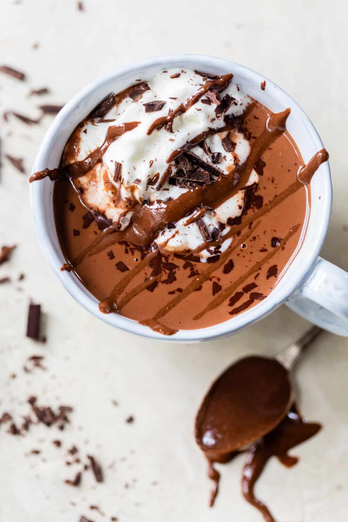 mug of hot chocolate with whipped cream and chopped chocolate