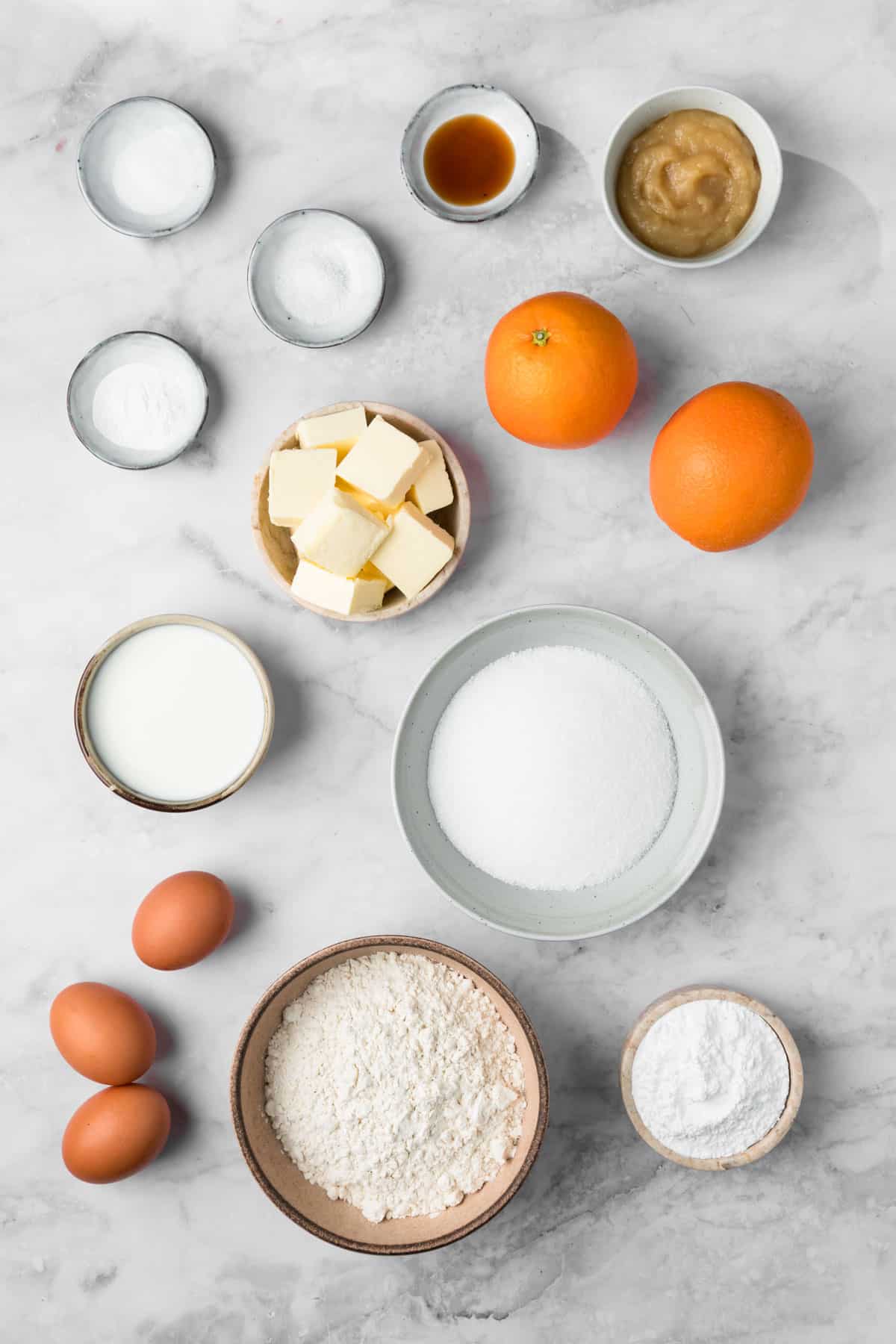 overhead view of the ingredients for orange cake in individual bowls.