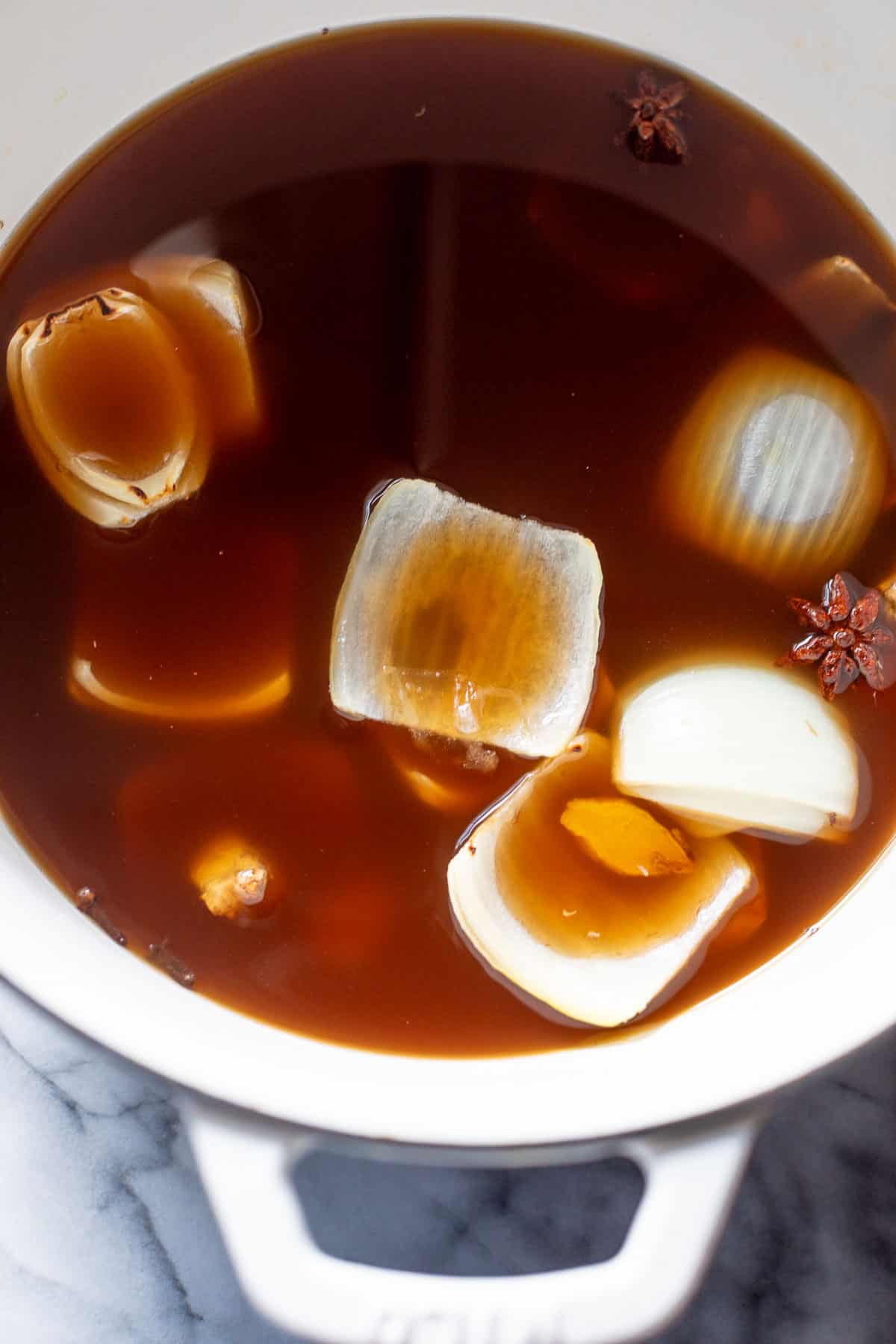 overhead view of paleo beef pho broth in a large pot.