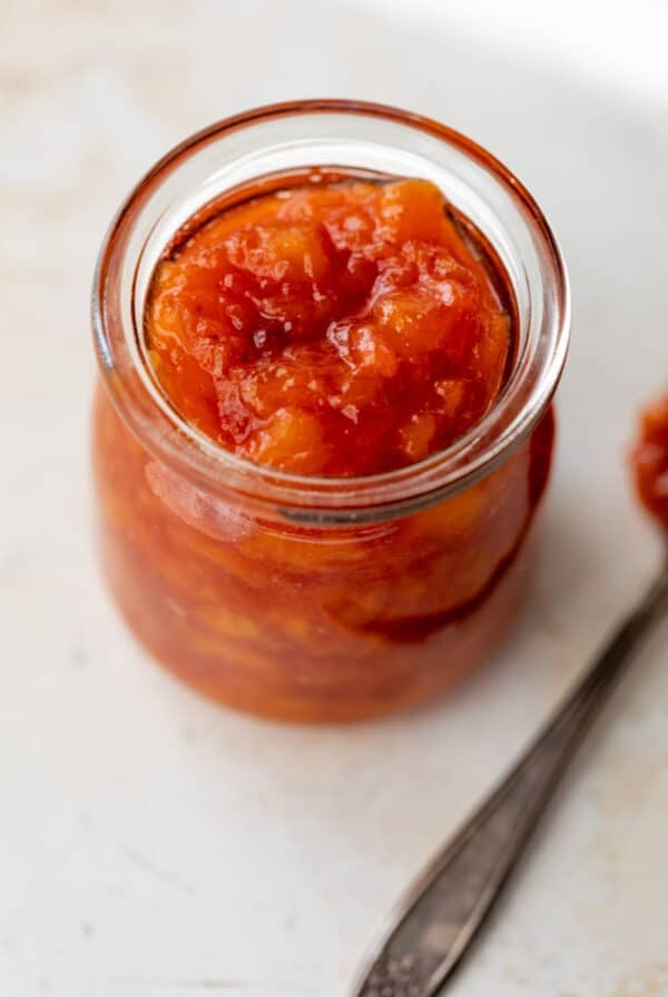 close up on a jar of peach preserves.