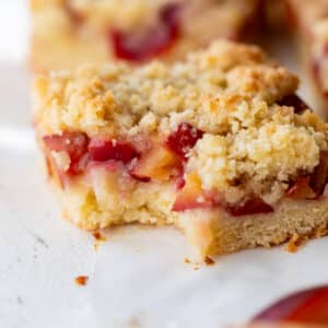 close up on a plum bar with a bite taken out of it.