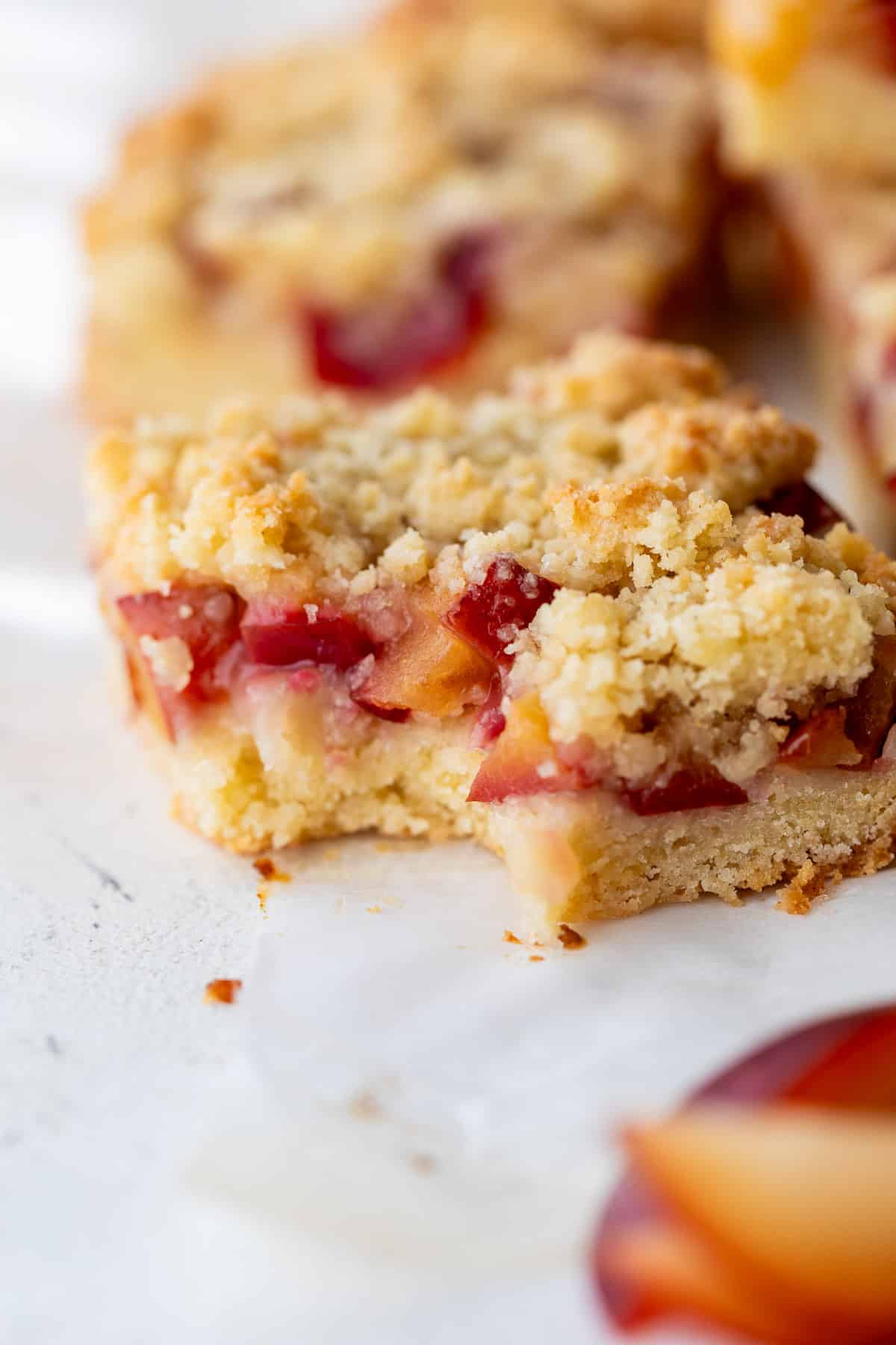 close up on a plum bar with a bite taken out of it.