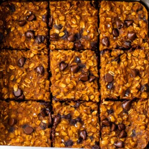 baked pumpkin oatmeal in a baking dish sliced into 9 squares