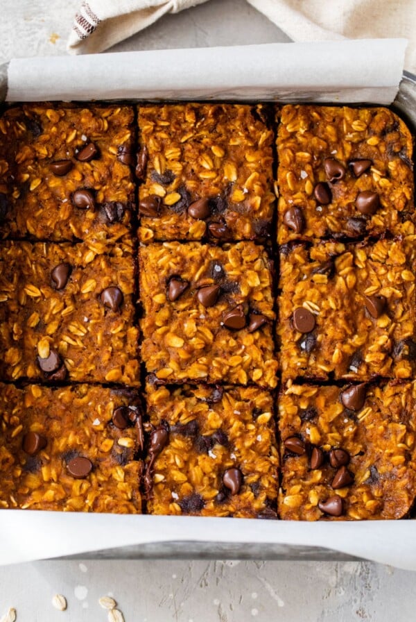 baked pumpkin oatmeal in a baking dish sliced into 9 squares