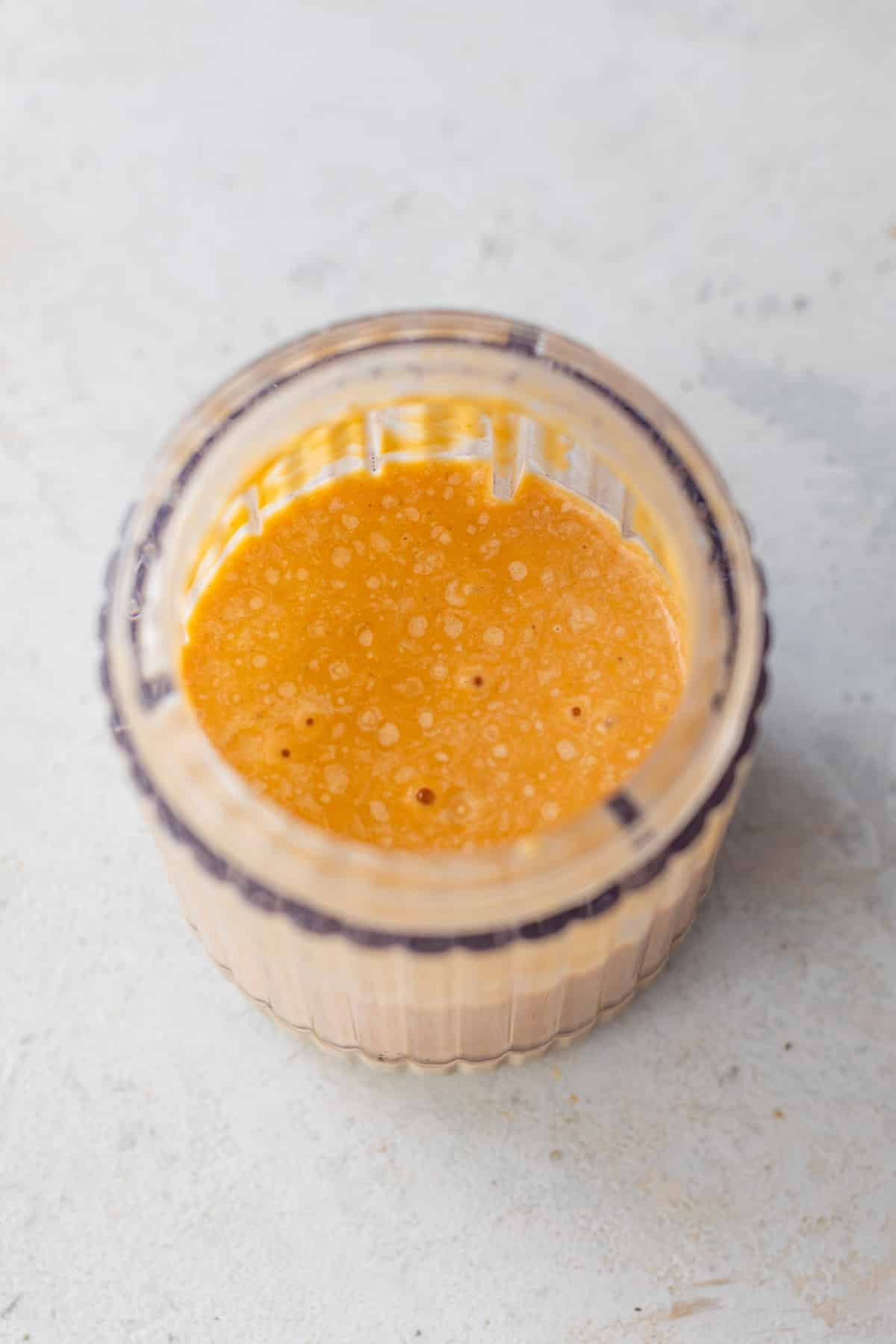 smooth and creamy pumpkin milk in a glass jar.