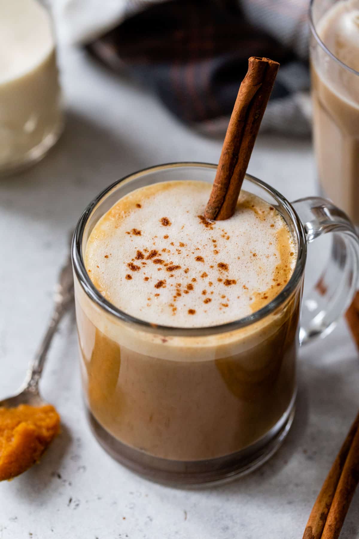 overview of a pumpkin spice latte with a cinnamon stick