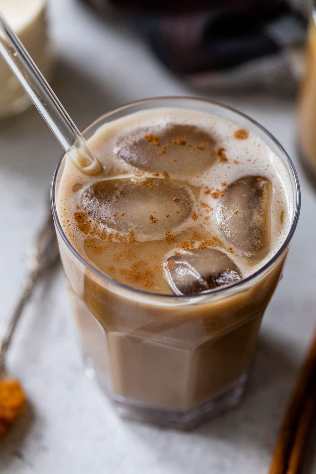 overview of an iced pumpkin spice latte with a straw