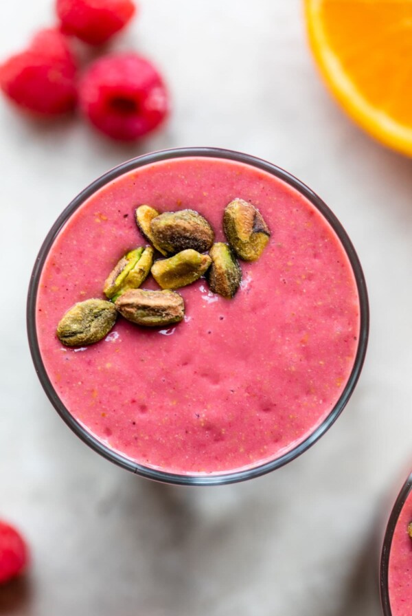 raspberry smoothie topped with pistachios