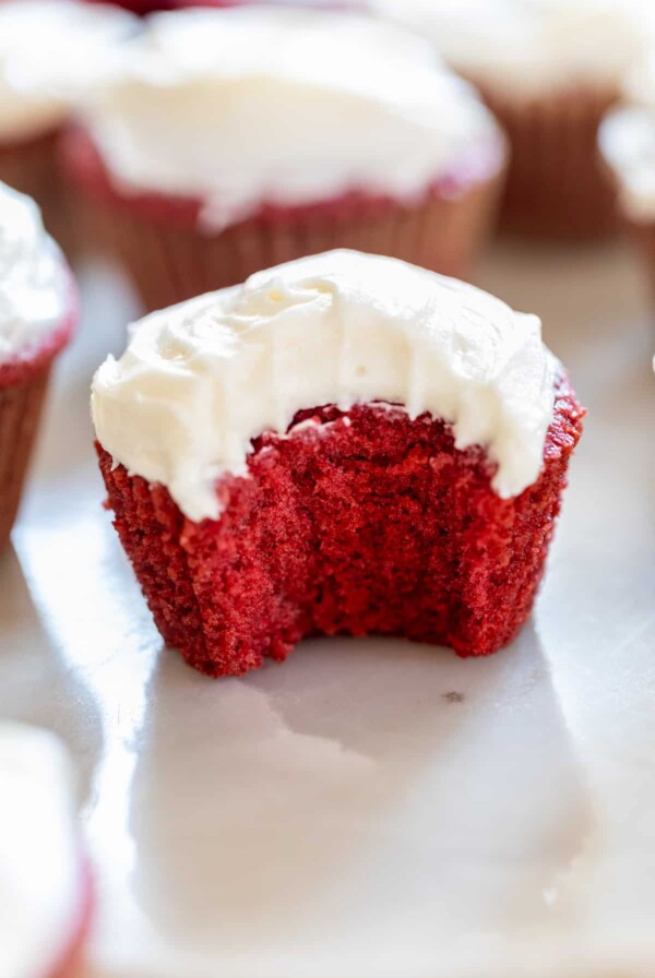 a red velvet cupcake with a bite taken out