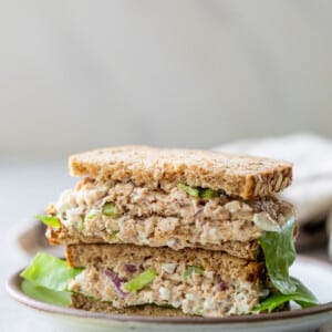 salmon salad sandwiches stacked on top of each other.