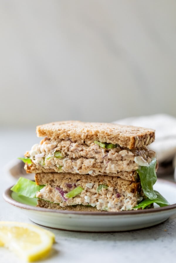 salmon salad sandwiches stacked on top of each other.