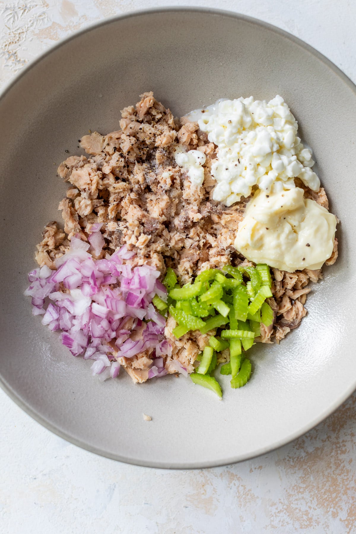 the ingredients for salmon salad together in a bowl.