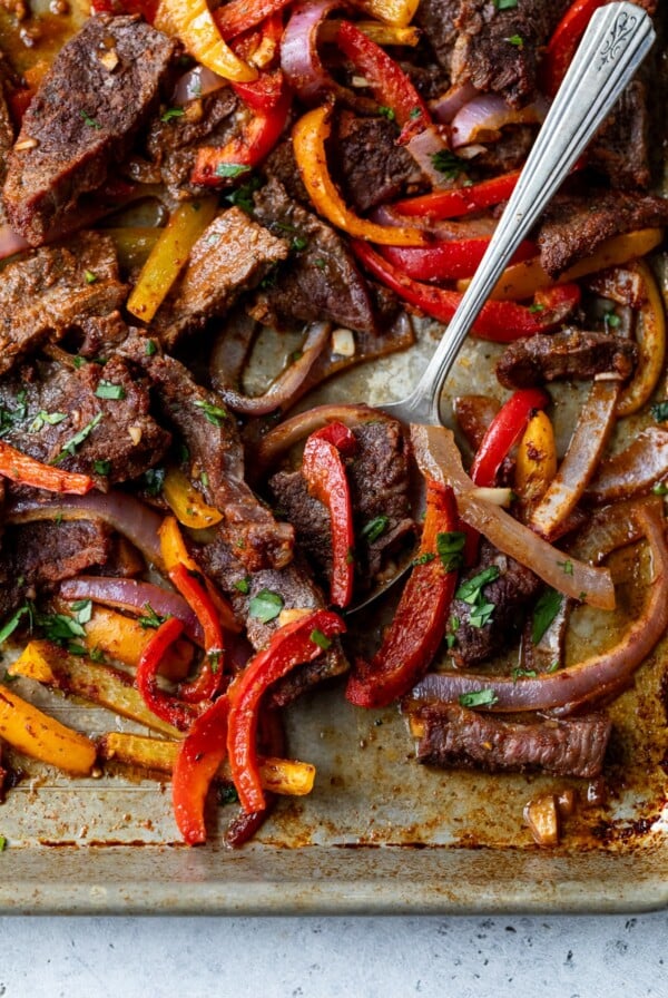 sheet pan fajitas with a spoon
