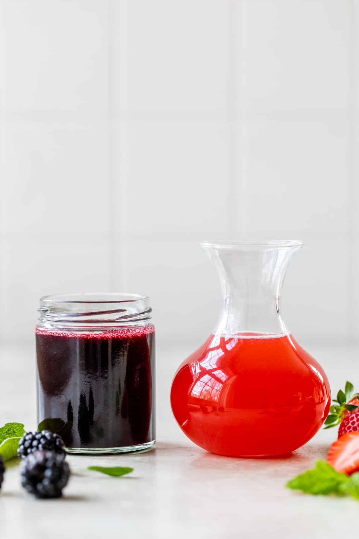 two jars filled with colored simple syrup