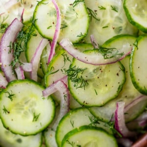 close up on a simple cucumber salad in a wood bowl.