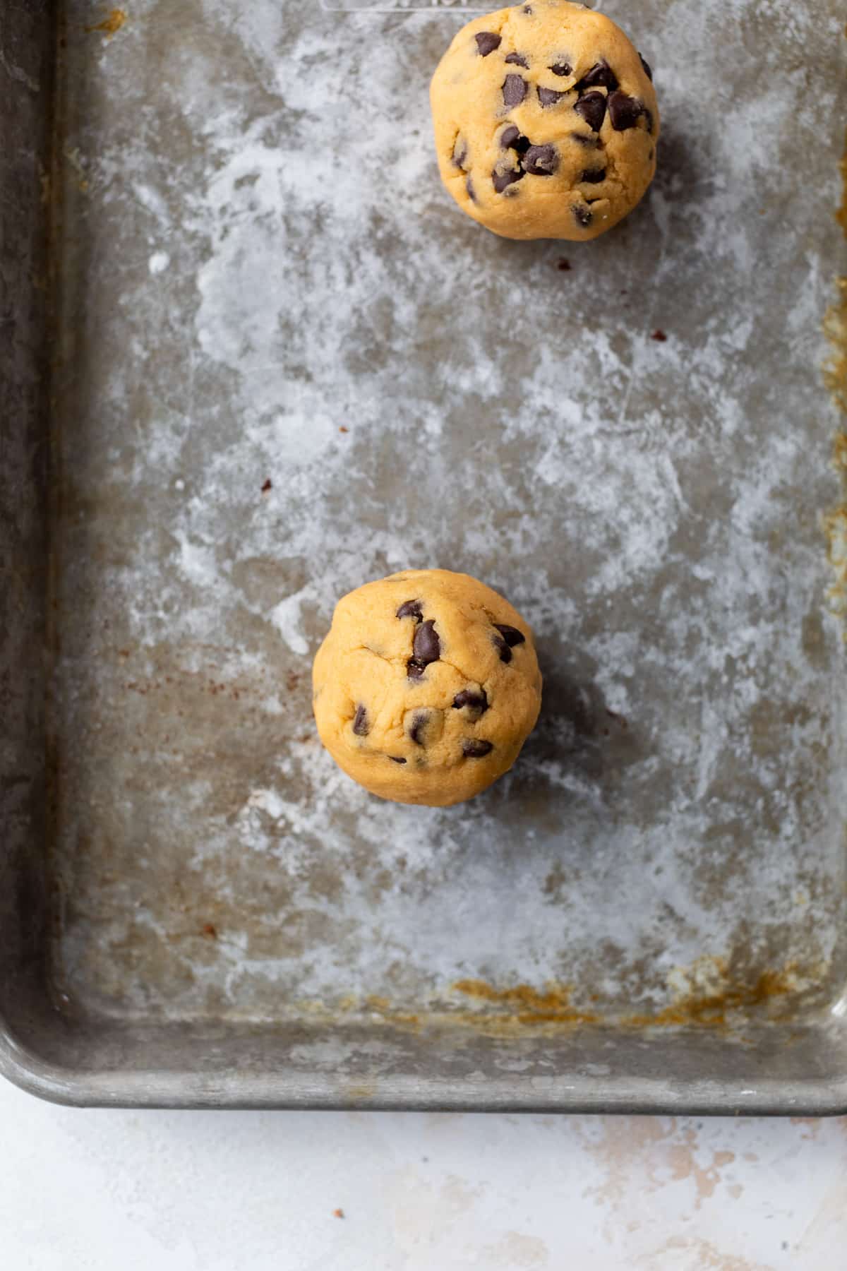 cookie dough balls on a baking sheet