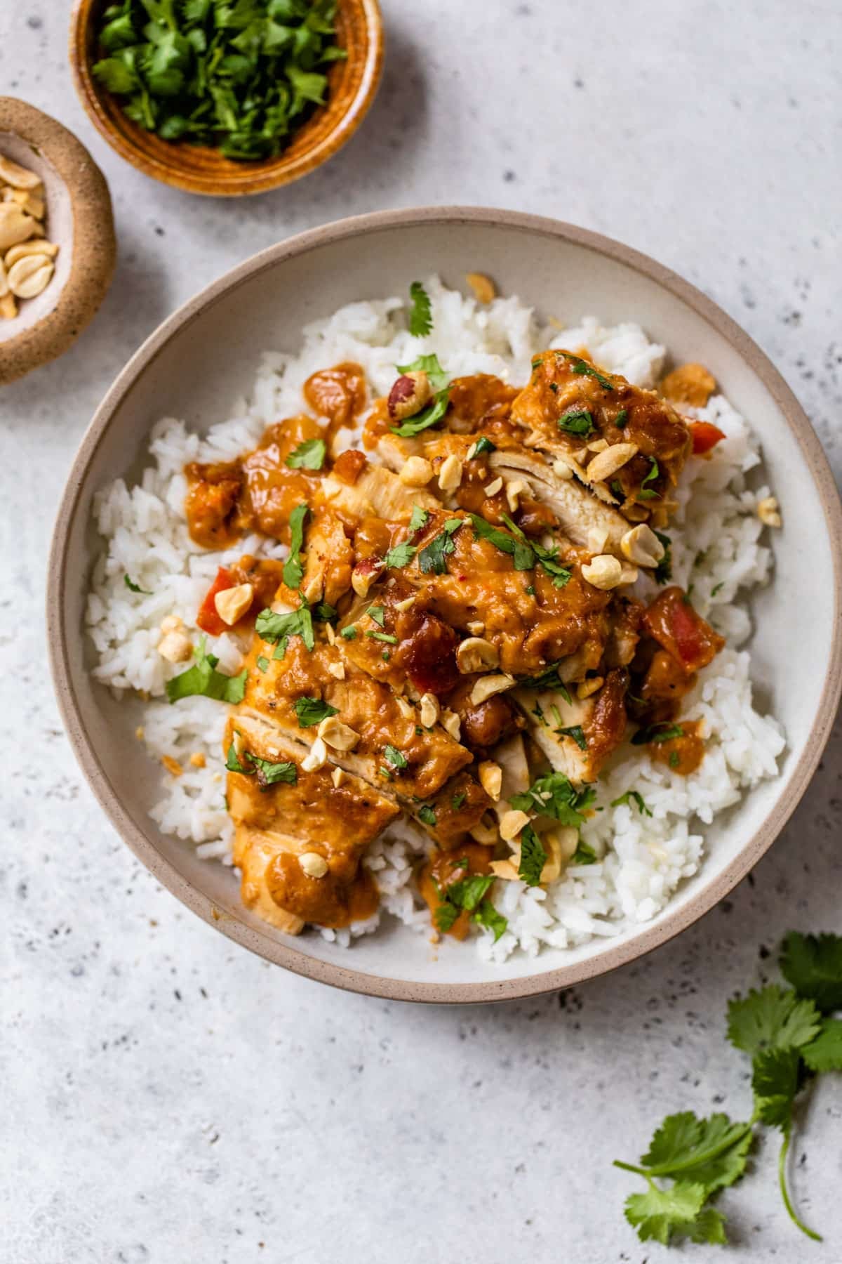 slow cooker peanut chicken on top of rice on a plate