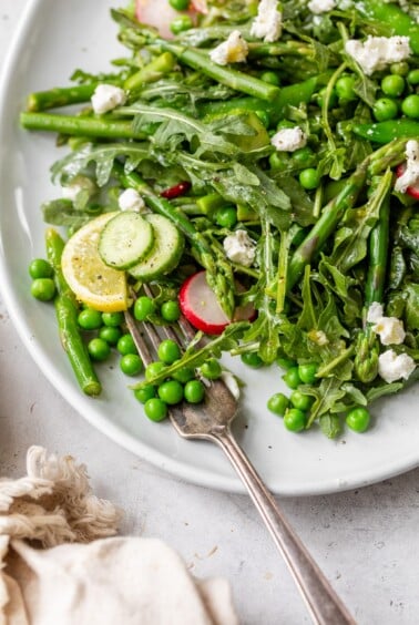 spring pea salad on a serving platter with a fork