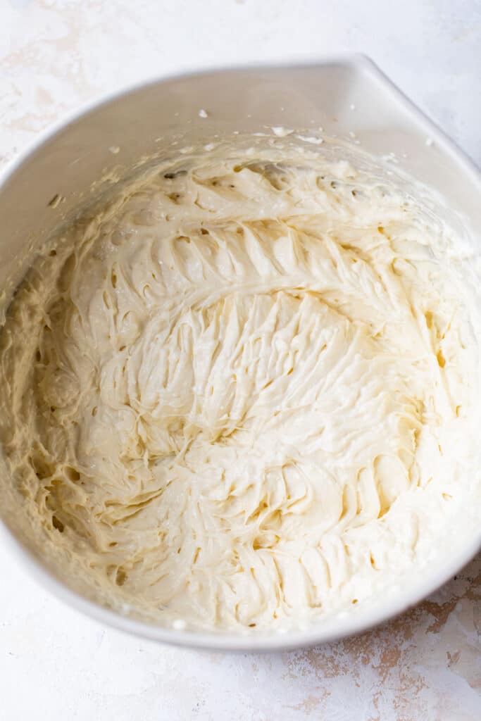 cheesecake filling in a large white mixing bowl