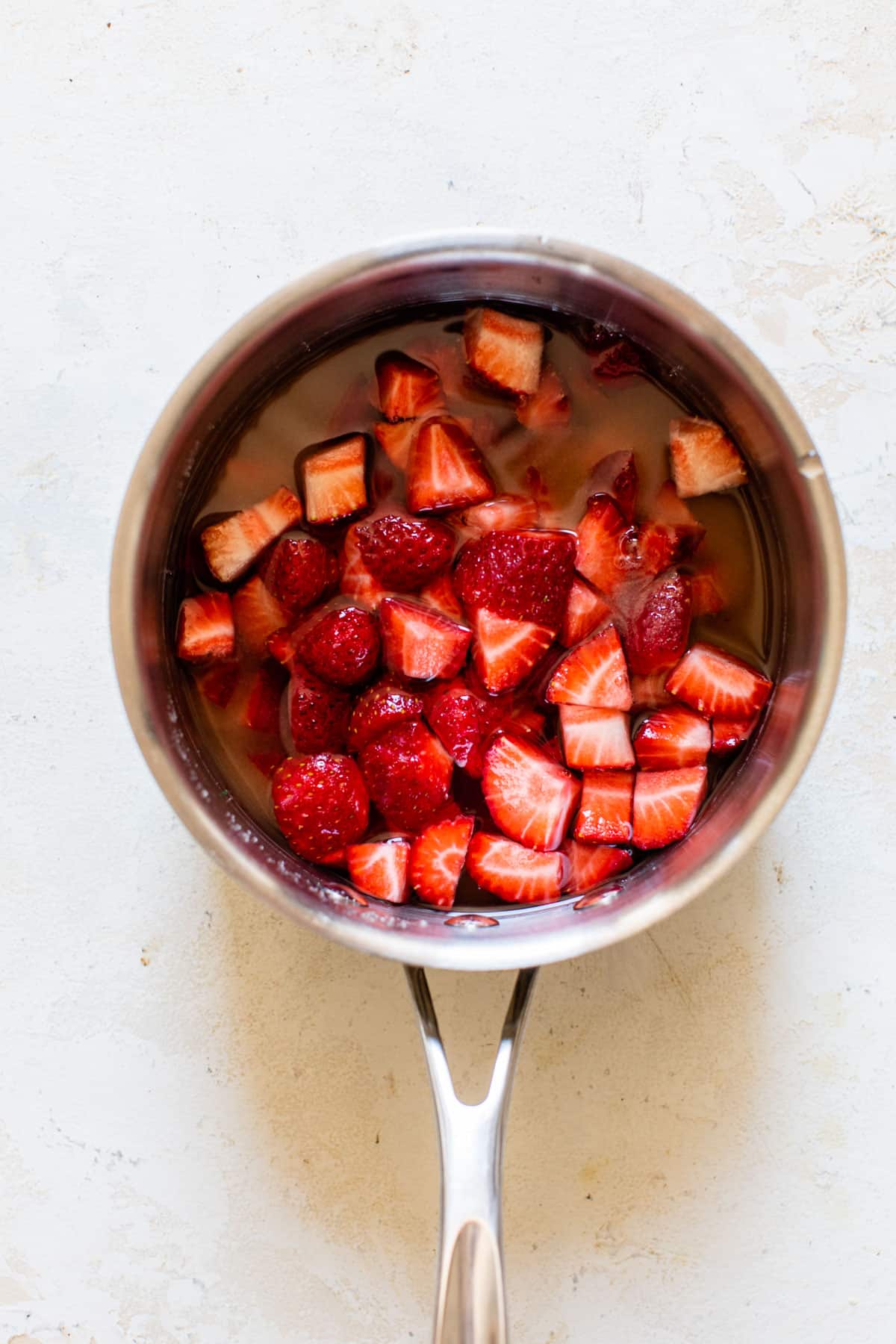 strawberries, sugar, and water in a saucepan