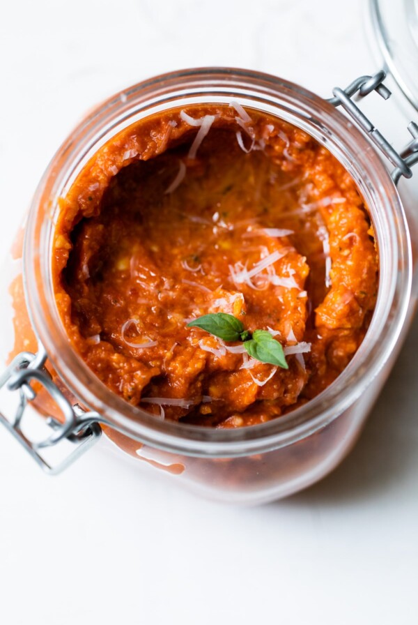 jar of sun dried tomato pesto topped with parmesan cheese