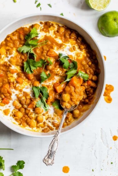 chickpeas and lentils in a bowl topped with cilantro