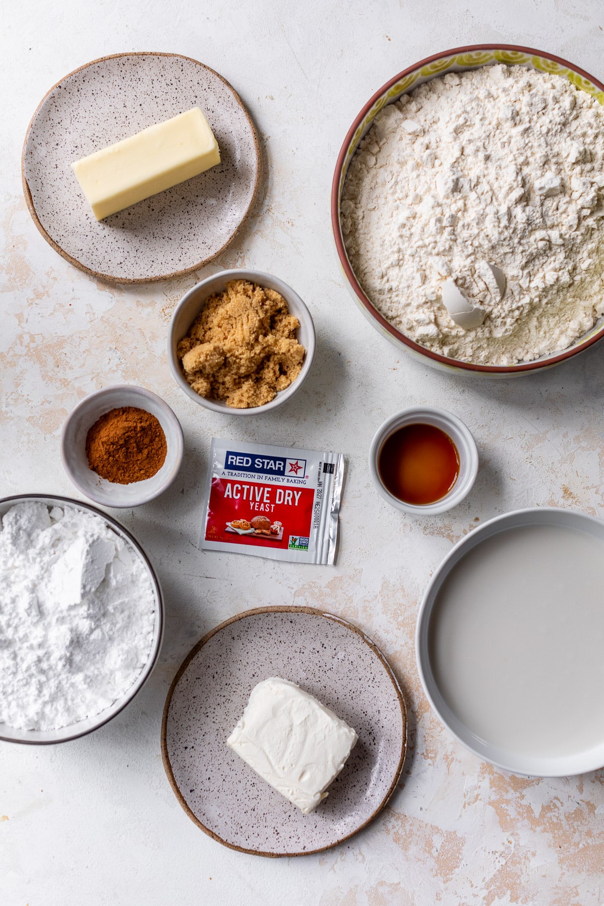 overhead view of the ingredients for vegan cinnamon rolls in individual bowls.