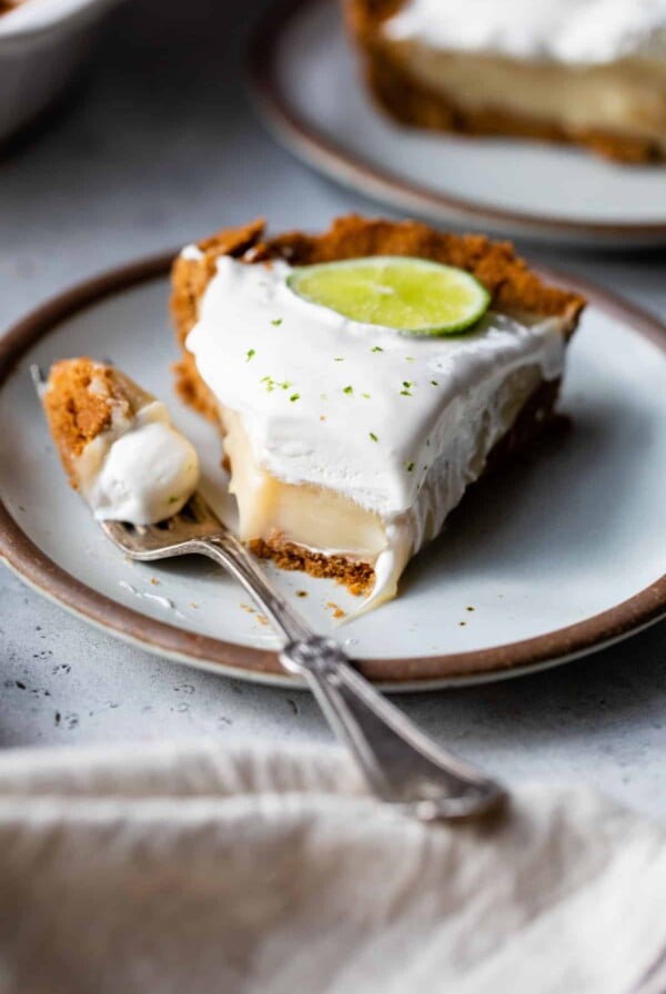 slice of vegan key lime pie on a plate with a fork